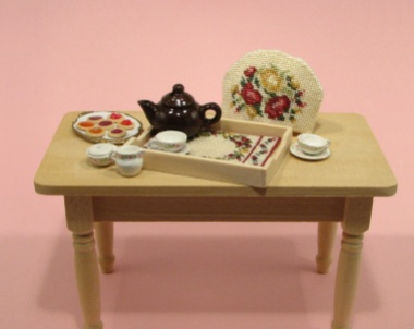 A doll's house scale tray cloth and teacosy, available as kits from www.janetgranger.co.uk