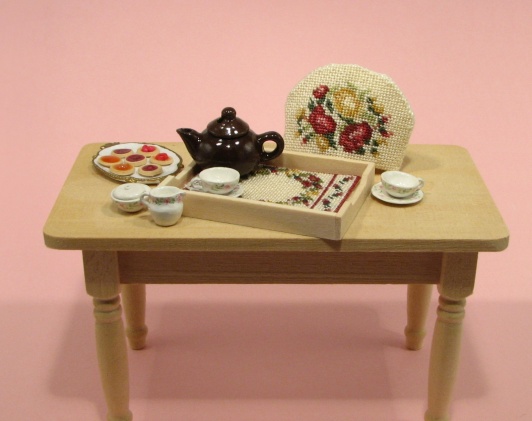 A doll's house scale tray cloth and teacosy, available as kits from www.janetgranger.co.uk