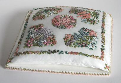 This is a pincushion design that was featured in Inspirations magazine. The pincushion is stitched in various embroidery stitches, and measures nearly five inches square