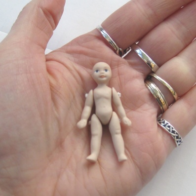 This tiny the doll is only 1 3/4 inches high. Yup. Weeny!