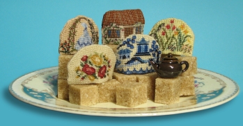Tiny tea cosies, stitched on 32 count silk gauze. Kits available from www.janetgranger.co.uk
