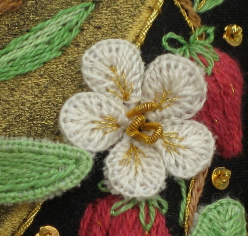 Scarily large image of a stumpwork strawberry flower that's only really 3/4 of an inch across